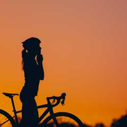 silhouette-of-a-woman-riding-a-bike-during-a-sport-2023-06-08-18-14-21-utc